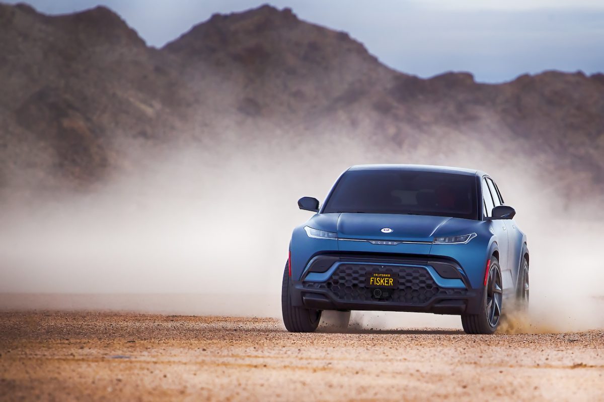 A car driving on a dusty path